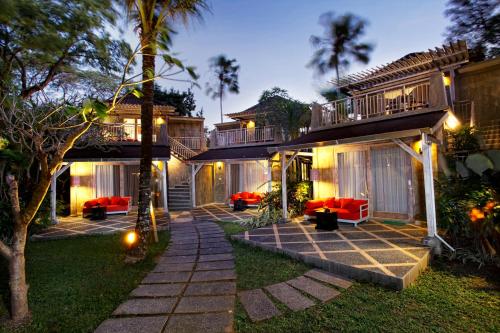 a house with a patio and a porch at night at Segara Village Hotel in Sanur