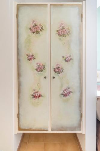 a pair of doors with flowers painted on them at Agia Markella in Chios