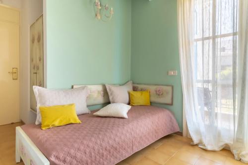 a bedroom with a bed with yellow and white pillows at Agia Markella in Chios