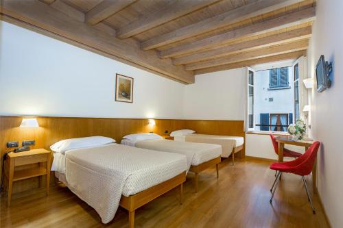 Säng eller sängar i ett rum på Hotel Tre Re