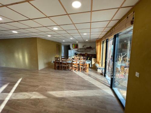 an empty room with chairs and a dining room at Holiday home on farm (La Ferme du Tao) in Beaugies-sous-Bois