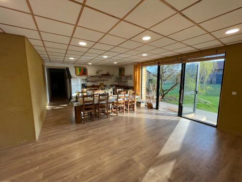 a dining room with a table and chairs at Holiday home on farm (La Ferme du Tao) in Beaugies-sous-Bois