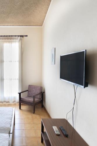 a living room with a flat screen tv on the wall at Agia Markella in Chios