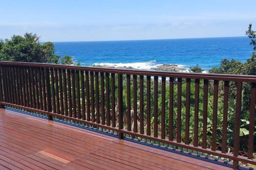 a wooden deck with a view of the ocean at On The Beach @ South Sands.No 2 in Port Edward