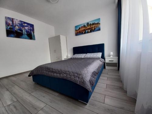 una camera da letto con un letto e un pavimento in legno di Studio Acasă a Sibiu