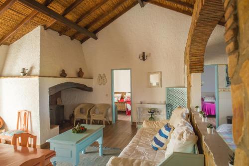 a living room with a couch and a table at Monte Varginhas Porto Covo in Porto Covo