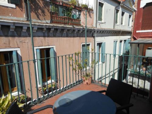 a table and chairs on the balcony of a building at Cà Del Dose in Venice