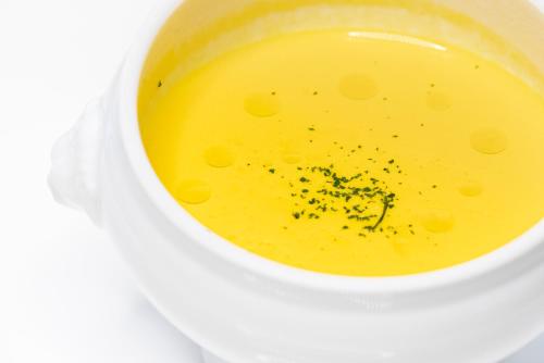 a white cup of soup with yellow liquid at Minami Aso Luna Observatory Auberge Mori no Atelier in Minami Aso