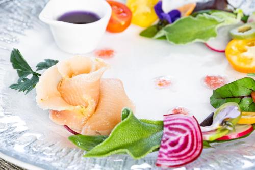 a plate of food with vegetables and a cup of coffee at Minami Aso Luna Observatory Auberge Mori no Atelier in Minami Aso