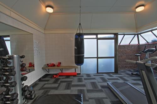 a gym with a punching bag hanging from the ceiling at Rosebank Lodge in Balclutha