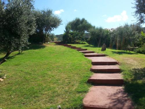 a path in a field with grass and trees at Hotel Giardino Corte Rubja in Iglesias