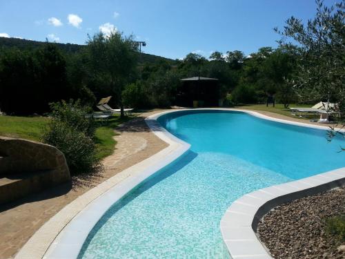 a swimming pool in a yard at Hotel Giardino Corte Rubja in Iglesias