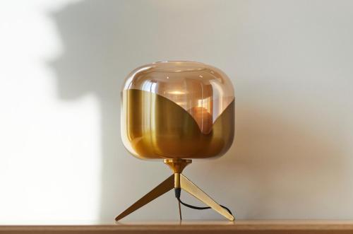 a glass lamp on a table in a room at Les Chants d'Ailes - Hôtel Face Mer in La Turballe