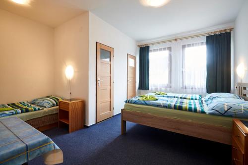 Postel nebo postele na pokoji v ubytování Hotel Sklárna Harrachov