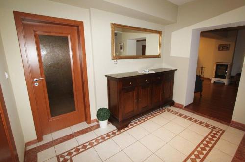 a bathroom with a sink and a mirror and a door at Apartmán U krále - 1 in Jičín
