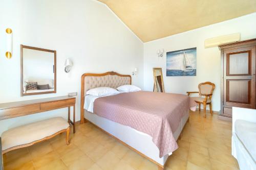 a bedroom with a bed and a table and a desk at Agia Markella in Chios
