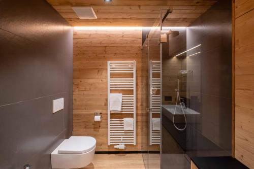 a bathroom with a toilet and a sink at Residence Salvan in Corvara in Badia