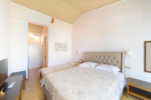 a bedroom with a large bed and a desk at Agia Markella in Chios