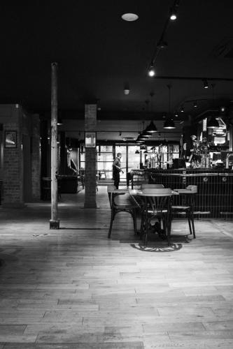 a black and white photo of a table and benches at Fountain Hotel in London