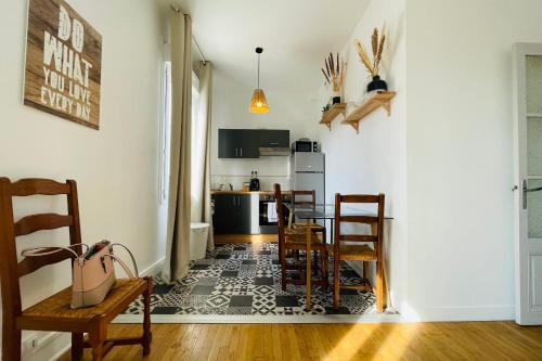 une cuisine et une salle à manger avec une table et des chaises dans l'établissement The Timeless - Balzacien, à Tours