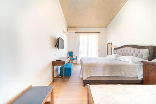 a bedroom with a bed and a desk and a window at Agia Markella in Chios