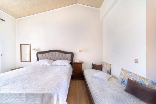 a bedroom with a bed and a couch in it at Agia Markella in Chios