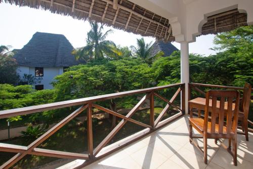 a chair on the porch of a house at Veraclub Sunset Beach in Nungwi