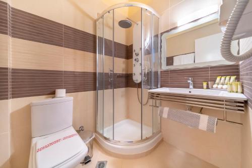 a bathroom with a shower and a toilet and a sink at Agia Markella in Chios
