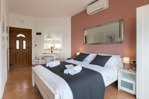 a bedroom with a large bed with a mirror at Apartmani Škopac Rabac in Rabac