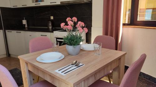 a wooden table with plates and napkins on it at NETWORK apartment in Jajce