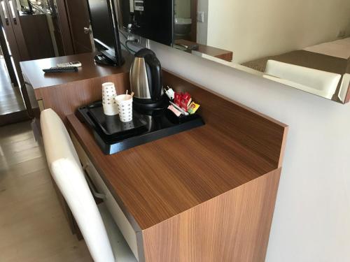 a kitchen counter with a coffee maker on it at The Corner Park Hotel in Antalya