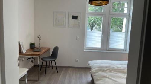 a bedroom with a bed and a desk and a window at Apartment in zentraler Lage zur Dortmunder Innenstadt in Dortmund