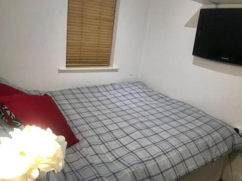 a small bedroom with a bed with a window at Central 2 Bed, 2 Bathrooms, Ground Floor Apartment with Parking in Bishops Stortford