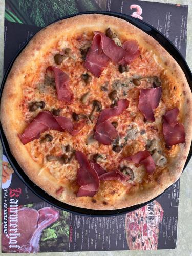 a pizza sitting on top of a pan at Hotel Kammerhof in Mariastein
