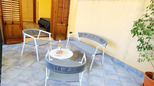 a table and two chairs and a table with a cake on it at Hotel Cala Marina in Castellammare del Golfo