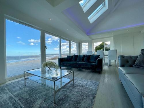 a living room with a couch and a glass table at Filey Beach House in Filey
