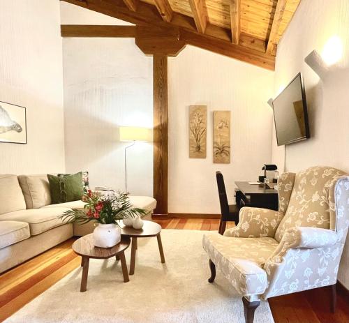 a living room with a couch and a table at Molino de Alcuneza Relais & Châteaux in Sigüenza