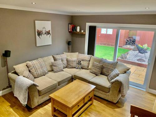 a living room with a couch and a table at In the heart of Inverness in Inverness
