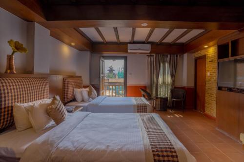 
a bedroom with a large bed and a large window at Pahan Chhen - Boutique Hotel in Kathmandu
