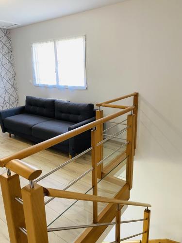 a staircase in a living room with a couch at TENAT ER VORC'H - Maison neuve Erdeven - KC3 in Erdeven