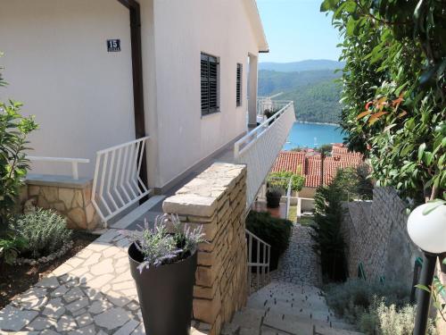 a balcony of a house with a view of the water at Apartment Katarina - RAC174 by Interhome in Rabac