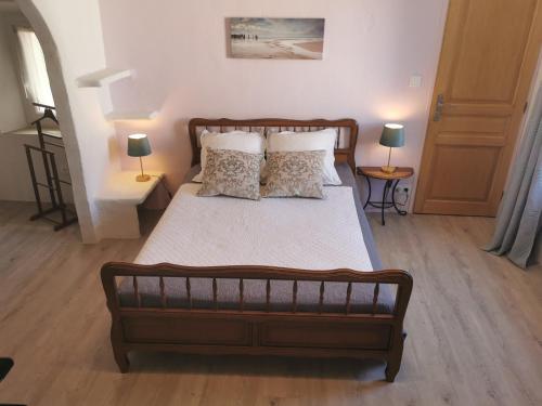a bedroom with a large bed with two pillows at 1832 La Rabassière in Malaucène