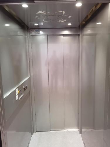 an elevator in a building with a glass door at Mansarda Trentino-Campiglio in Ossana