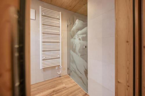 a room with a closet with white walls and a window at Kaser Premium Chalet am Berg in Neustift im Stubaital