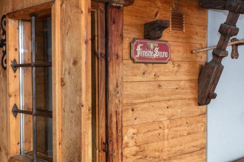 a sign on the side of a wooden wall at Klawunn Hotel & Apartement in Kaprun