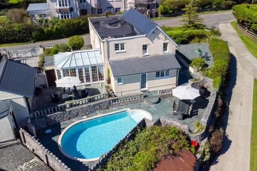 an aerial view of a house with a swimming pool at Windy Ridge - 5 Bedroom Holiday Home - Oxwich in Oystermouth