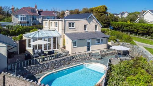 an aerial view of a house with a swimming pool at Windy Ridge - 5 Bedroom Holiday Home - Oxwich in Oystermouth