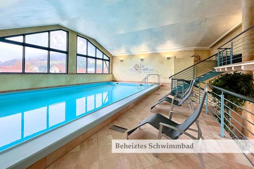 a swimming pool in a house with a swimming pooliterator at Hotel Rose in Baiersbronn