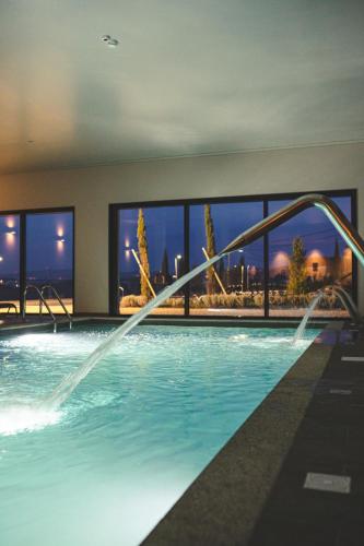 a swimming pool with a view of a city at MW Douro Wine & Spa in Santa Marta de Penaguião