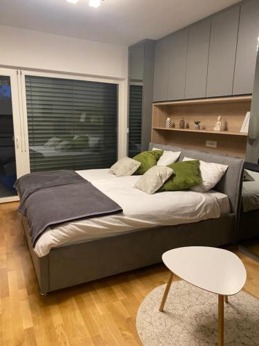 a large bed with green pillows in a bedroom at Oasis of Energy in Ljubljana